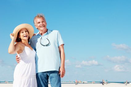 A retiree couple enjoying a summer vacation by the beach