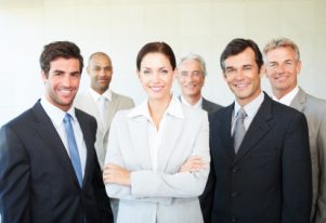 Portrait of happy professional business people posing together and smiling